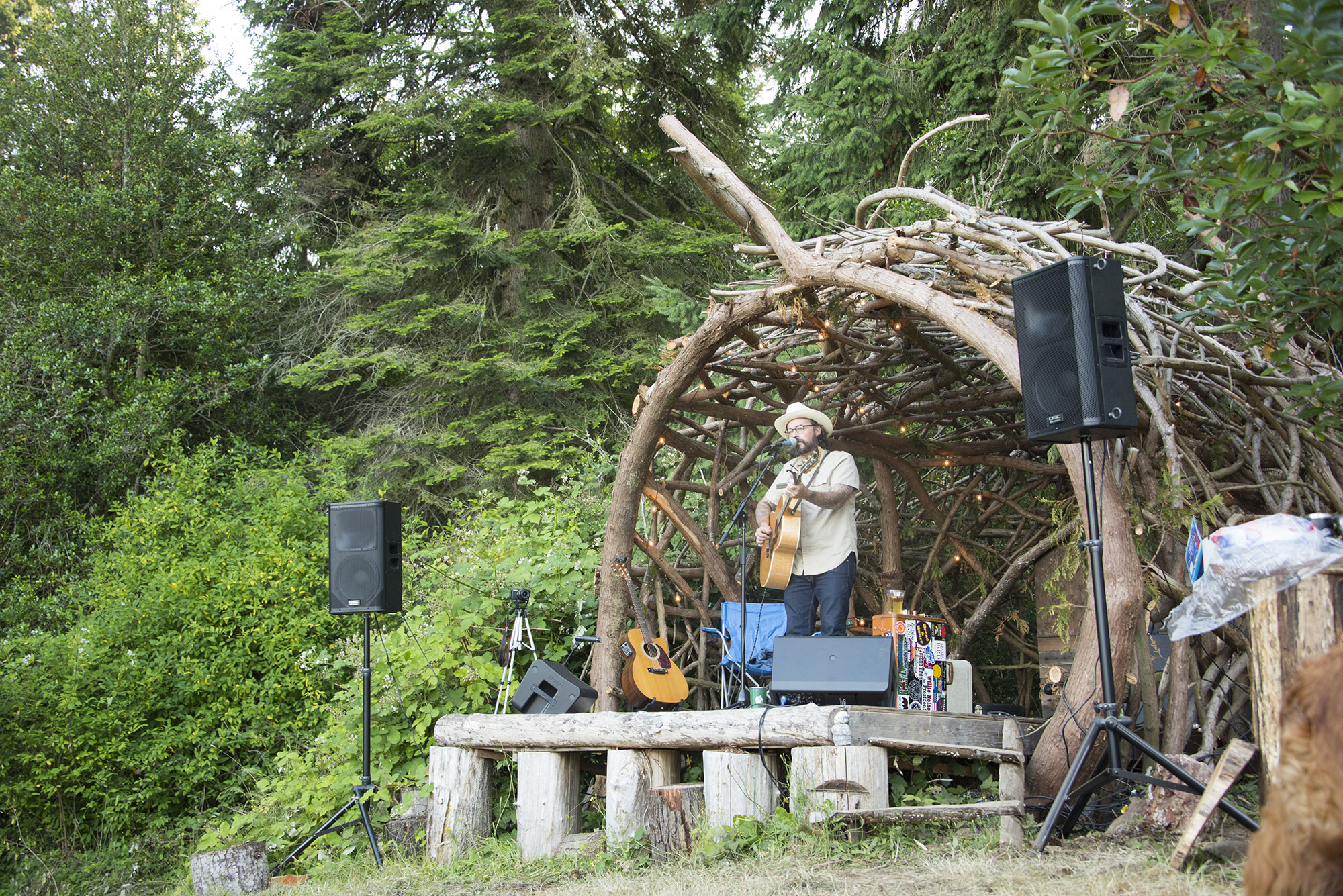 Mike Jack kicking off his first set earlier in the day nestled into the arches and entwined branches of the cedar limb stage | photo: Austin Iles Mike Jack Plays Pilot Point Rendezvous 2019