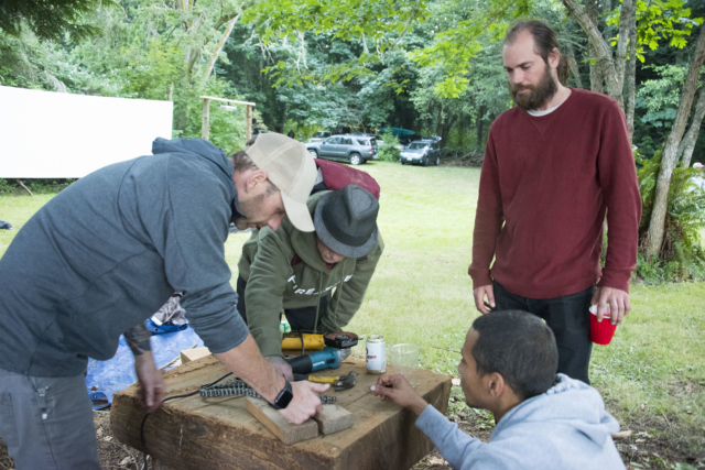 Beau, Adam, Boogy, and Bobby repairing a drive chain, to get Bobby’s bike road ready for the return trip home | photo: Illes Bobby Dodd | Toebock American Folklore