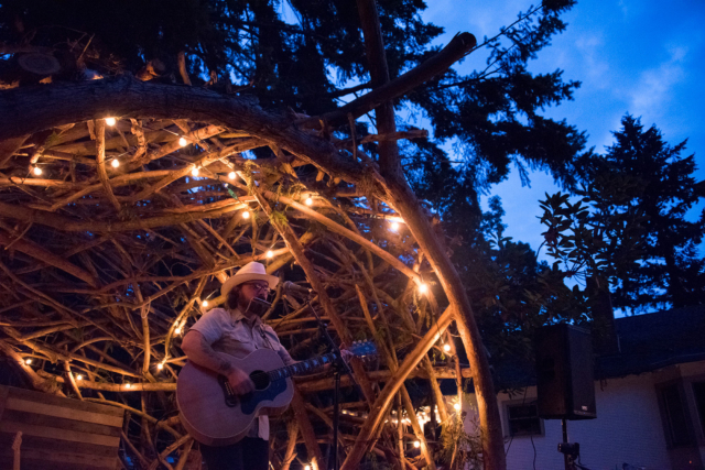 Mike Jack kicking off his first set earlier in the day nestled into the arches and entwined branches of the cedar limb stage. | photo: Austin Iles