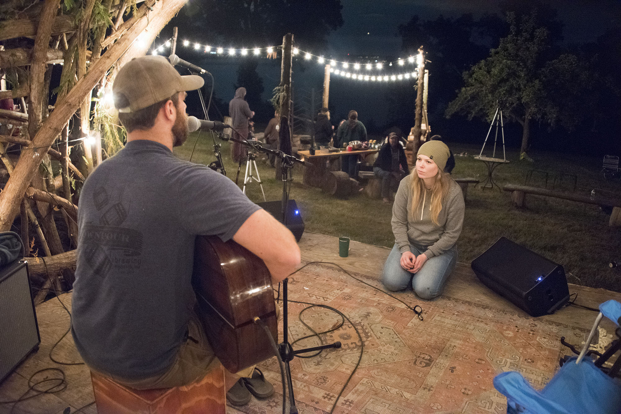 Andrew (of Lewis Knives) serenades his wife, Christy, and other campers late night on the Cedar stage. Late night open mics, and jam sessions are known to last deep into the night, and retiring just before sunrise | PHOTO: iLLES Lewis Knives | Musical Performance