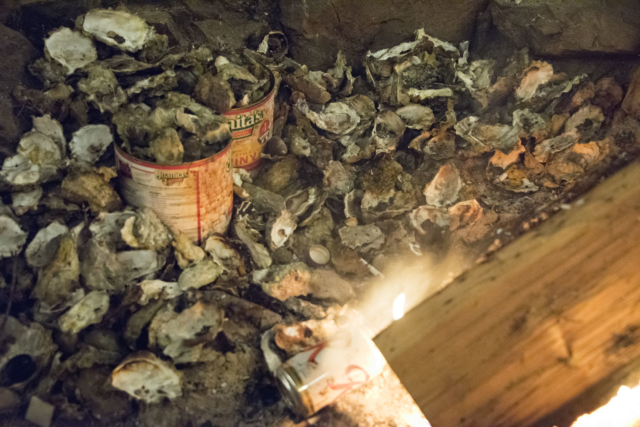 Empty oyster shells litter the cooking pit. Non stop shuck service, and garlic butter topping provided by Charlie Burke | photo: Illes Pilot Point Rendezvous 2019 | Hosted x Austin Illes